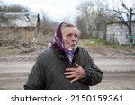 Small photo of An elderly woman cries near her destroyed house after the Ukrainian army liberated her village from Russian occupiers in Kyiv region, Ukraine. April 21, 2022.