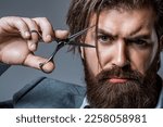 Small photo of Barber scissors. Vintage barbershop, shaving. Male in barbershop, haircut, shaving. Bearded man isolated on gray background. Mans haircut in barber shop. Barber scissors, barber shop.