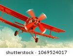 Red Biplane Flying In The...