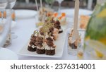 Small photo of Buffet indoors. Catering business waiter. Catering on a banquet table with appetizers-canapes in a restaurant or hotel. Snacks on the table, catering concept.