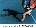 Small photo of Portrait of a healthy athletic man in retro style with an athletic build with a tennis racket. Redhead guy playing tennis on the sports ground. Portrait of a healthy athletic man with an