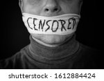 Bandaged mouth of a man with the word censored in English