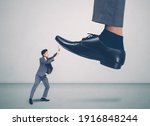 Small photo of foot of leader or boss with authority huge trample on frightened employee with bullying, businessman in suite strong and defense, exploitation and dominance, scared and fight, business concept.