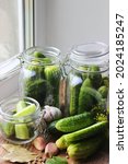 Small photo of Canned cucumbers, pickled cucumbers Glass jar with pickled cucumbers on a wooden background. Canning of fresh homemade cucumbers. Selective focus. nature