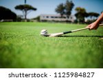 Small photo of Young adult lifting slither onto a hurl playing hurling in the park