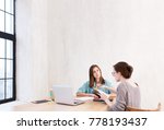 Small photo of Two young creativa designer discuss about business of company in modern loft office. Two woman are talking about work stress and more serious. Copyspace on background wall