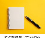 notebook,pen, on yellow background. top view copy space 