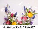 floral layout from different wildflowers on a white background. Beautiful light reflections. Top view. wildflowers flat lay 