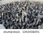 Small photo of Hands of people pulled with entreaty. Wat Rong Khun (White Temple) in Chiang Rai city, Thailand. Religious traditional national Thai architecture. Landmark, architectural monument of Chiang Rai. Money