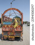 Small photo of ISLAMABAD, PAKISTAN – MAY 19, 2023: Touirts child and traditional national truck in Islamabad city, Pakistan