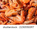Frozen shrimp. Seafood on the counter. Fish market. Close-up shooting of seafood. Box with shrimp. Photo of shrimp in the supermarket. Wholesale of fish.  Peeled shrimp.