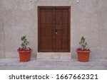 a vintage brown door with two pots