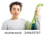 Small photo of Hispanic boy in white long sleeved shirt holding some extravagant and tawdry green ties