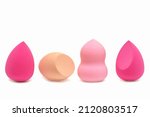 Makeup sponges of different colors and different shapes on a white background