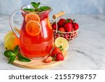 Strawberry lemon lemonade with mint in jug. Summer refreshing drink.  Detox fruit water. Selective focus. Copy space