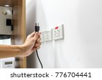 Small photo of Hand are plugged in or unplugged electricity. Separated from a white background.