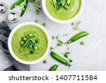Summer cream soup with green fresh pea shoots. Top view