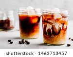 Almond Milk Cold Brew Coffee Latte in glass jar on a gray stone background