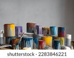 Small photo of Old Paint Cans, copy space, background. Cans of colored paint. Oil-based enamel, lacquer, shellac and varnish leftovers. Household Hazardous Waste