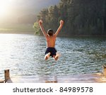 Young Boy Jumping Into Lake