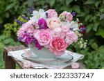 romantic bouquet of pink roses, sweet peas, lavender and jasmine flowers in vintage sauce boat