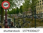 Small photo of Amsterdam, Holland, August 2019. In the central red-light district, a street alcohol prohibition sign. The graphic of the cartel is unequivocal. In the background a typical city canal.