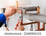 Small photo of Plumbing concept or service water worker. copper pipeline of a heating system in technical room. Boiler and expansion expansion tank system, detail of pressure gauge.