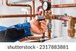Small photo of Plumbing concept or service water worker. copper pipeline of a heating system in technical room. Boiler and expansion expansion tank system, detail of pressure gauge.