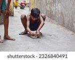 Small photo of KOLKATA , INDIA - MARCH 25, 2018: Goli or marbles is a riveting game. At stake are your own marbles which you bring to the arena. Using one's own set of glass balls, players gingerly flick