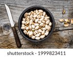 Small photo of Pistachios with bowl in a bowl on a rustic wood table. Nut, outright, healthy diet.