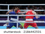 Small photo of BIRMINGHAM, ENGLAND - AUGUST 4: Aiden Walsh of Northern Ireland punches Mohammed Harris Akbar of England during the Men’s Over 67kg-71kg (Light Middle) - Quarter-Final fight of the Commonwealth Games.