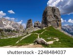 Cinque Torri Dolomites against blue cloudy sky, in Summer. Discover the beauty of the Italian Dolomites