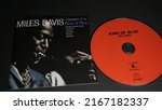 Small photo of Rome, Italy - June 11, 2022, cover and detail of the cd Miles Davis Kind of Blue, with Julian "Cannonball" Adderley, Paul Chambers, James Cobb, John Coltrane, Bill Evans, Wynton Kelly.