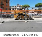 Small photo of Rome, Italy - July 08, 2022, detail of a Bobcat excavator for the remaking of the sutterranean pipes and the road surface for the viability.