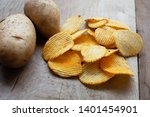 Small photo of Crispy slice potato chips and potato heads Placed on old wooden floors