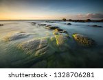 The beautiful mossy rock in the Beach of tindakon dazang in Sabah, Malaysia. Image is soft due and blurred due to long shutterspeed. - Image