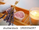 Small photo of Spiritual aura cleansing ritual bath for full moon ritual. Candles, aroma salt and lavender on tub table, close up
