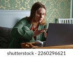 the woman works on a laptop with documents and corresponds at home in bed. the concept of remote work, work on sick leave. online business.