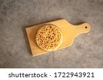 Small photo of Toasted Crumpet on a Wooden Board