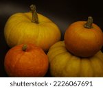 Four Pumpkins Over Black...