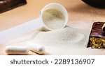 Small photo of spoons with Creatine, whey and casein, amino acid pills, food supplements and protein bar for physical exercises, gym in the background, muscle mass gain