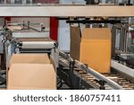 cardboard box of product packaging is moving on conveyor belt of automatic packing machine in the manufacturing factory ready for distribution to market. logistic manufacturing and industrial concept.