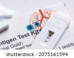 Small photo of Positive Covid-19 antigen test kit for self testing, one step coronavirus antigen rapid test, saliva swab, 1 test box, close up