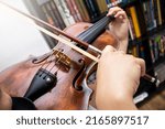 Small photo of Professional girl violinist playing an antique virtuous violin