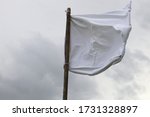 The white flag against the gray sky.  Surrender concept.