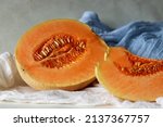 Small photo of Muskmelon, also known as Cucumis melo, is a species of melon belongs to gourd family. It has ribbed, netted or smooth skin and a sweet, or bland flavor with or without musky aroma. Sliced into halves