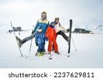 Small photo of 25th january, 2022 - Gudauri, Georgia: caucasian family of four in ski resort pose fro holiday photo in snowy mountains resort