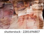 Beautiful color texture pink orange red yellow white color geological rock formations in city of Petra in Jordan