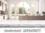 Small photo of Close up photo of contemporary kitchen island with marble table top with kitchen blurry loose focal of a giant arch windows background