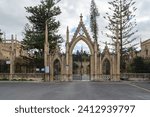Small photo of Paola, Malta - January 28th 2022: The entrance with a gatehouse on either side at the Santa Maria Addolorata Cemetery also known as the Addolorata Cemetery.
